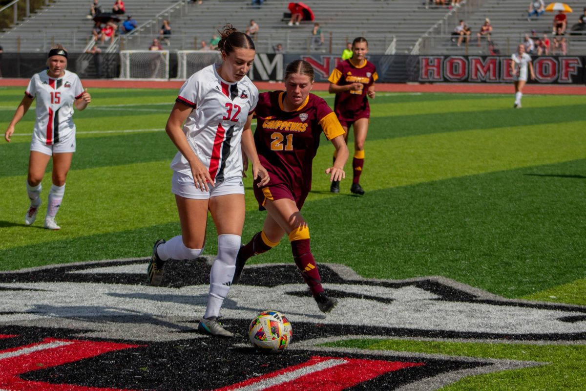 Sophomore midfielder Sarah Roy (32) beats Central Michigan University graduate midfielder Claudia Muessig to the ball. NIU women's soccer lost 2-0 to the Chippewas, failing to score a goal for the second-straight game. (Totus Tuus Keely | Northern Star)