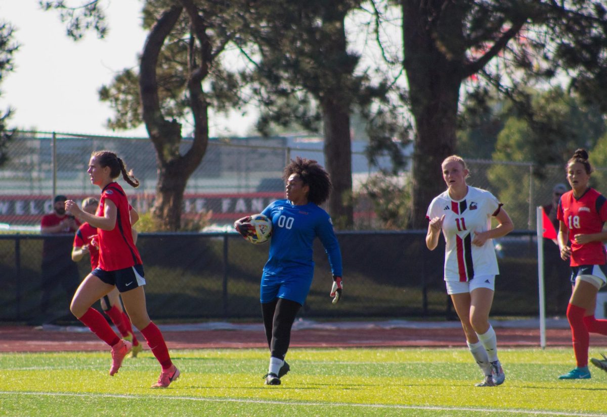 Graduate student goalkeeper Ary Purifoy (00) holds the ball and looks for a teammate downfield Thursday at the NIU Soccer and Track & Field Complex. Purifoy earned her second shutout of the season Sunday as NIU women's soccer defeated Oakland University 1-0. (Totus Tuus Keely | Northern Star)