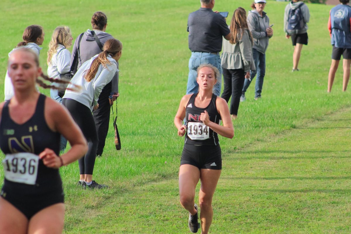 NIU graduate student Bailey Wilk (1934) is the first NIU cross country runner to reach the two-kilometer marker. Wilk placed eighth with a time of 18:57.59 Friday at the NIU Huskie Opener. (Totus Tuus Keely | Northern Star)