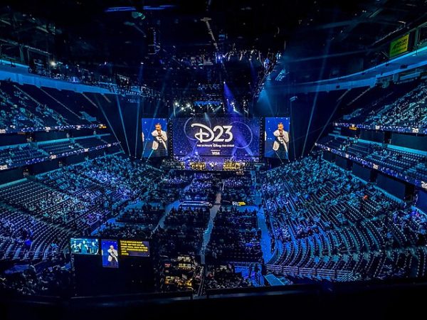 A large screen sits in an arena at the annual D23 expo. During this event, Disney announced multiple upcoming projects including "Frozen 3" and "Moana 2." (courtesy of Wikimedia Commons)