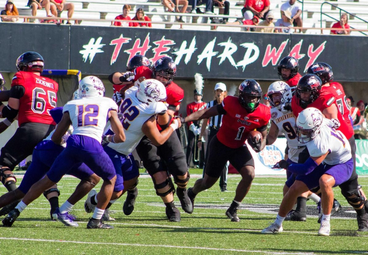 NIU senior running back Antario Brown (1) runs through an open gap in the Western Illinois University defensive line Saturday at Huskie Stadium in DeKalb. Brown finished with eight carries for 69 yards in NIU’s 54-15 blowout victory. (Totus Tuus Keely | Northern Star)