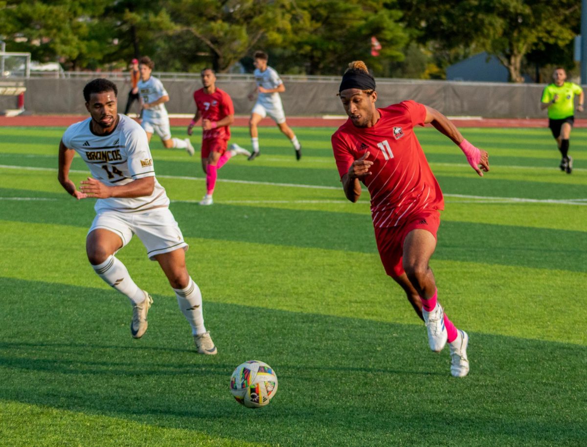 Sophomore forward Sam Divis (11) pushes forward with possession of the ball on Oct. 12 at the NIU Soccer and Track & Field Complex. Divis scored the only goal for NIU men's soccer as the Huskies lost 2-1 to the University of Evansville on Saturday. (Northern Star File Photo)