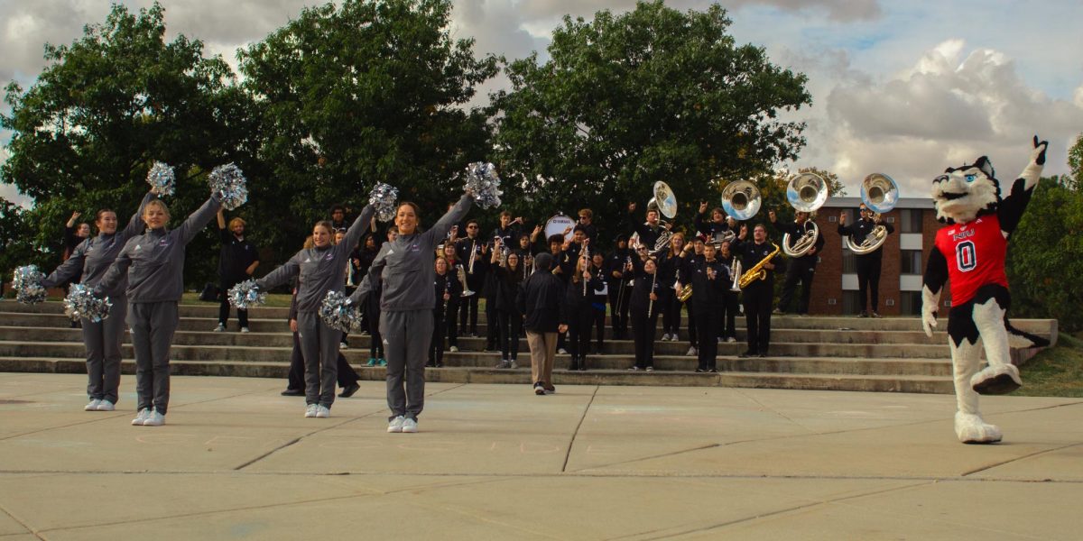 Victor E. Huskie, the Silverrettes and the Huskie Marching Band perform and dance at MLK Commons for the Second Annual Homecoming Kickoff event Monday. The marching band and Silverettes began their performance at noon. (Totus Tuus Keely | Northern Star)