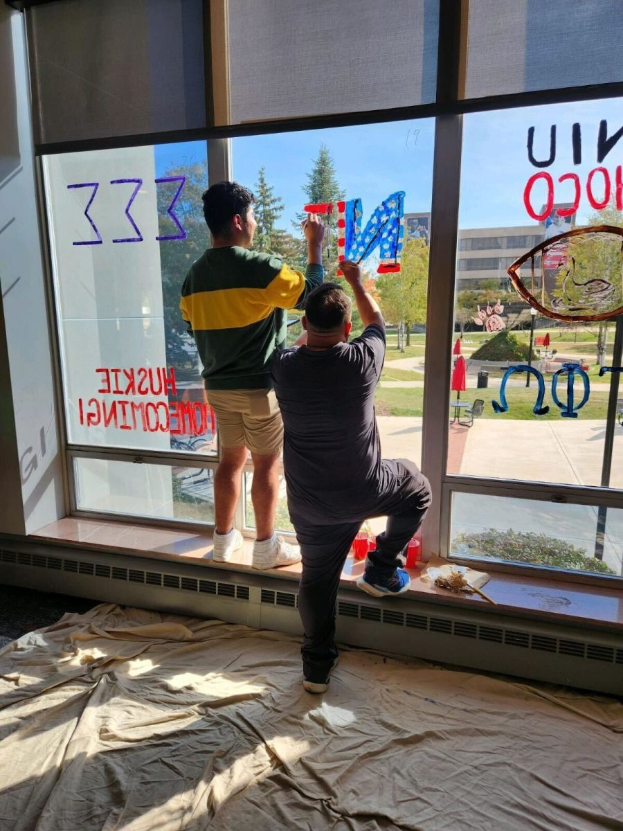 Members of the Student Veteran Association paint a window at the Holmes Student Center. The Student Veteran Association offers support to any student who is military connected. (Courtesy of Diego Torres)