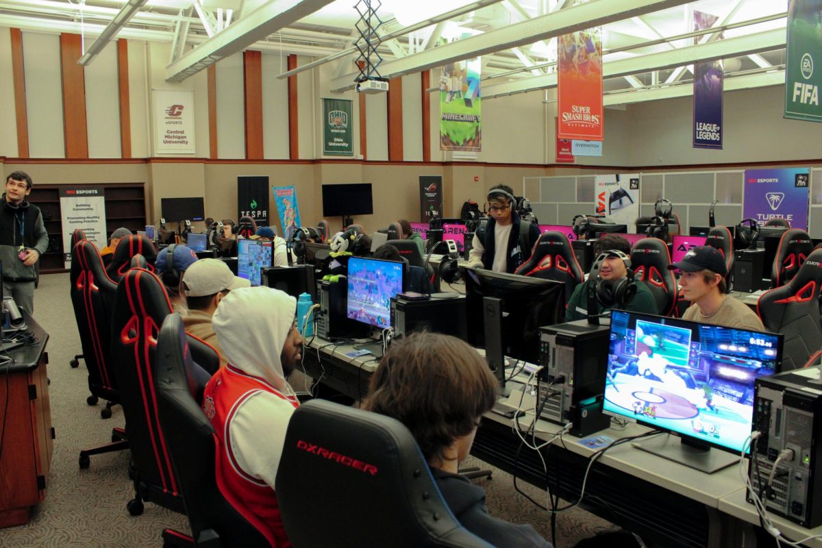 Students look at their screens as they play games during tournaments held at the NIU Esports Arena on Wednesday night. The games in the tournament included “Super Smash Bros. Ultimate” and “EA Sports College Football 25.”  (Ethan Rodriguez | Northern Star) 
