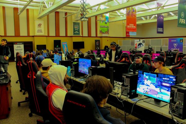 Students look at their screens as they play games during tournaments held at the NIU Esports Arena on Wednesday night. The games in the tournament included “Super Smash Bros. Ultimate” and “EA Sports College Football 25.”  (Ethan Rodriguez | Northern Star) 
