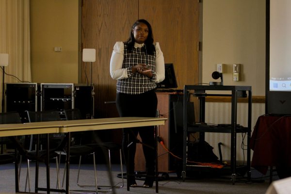 Ivory Rucker, former Student Government Association chairperson, holds the microphone and addresses the other senators during her speech. In a vote of 11-0-1, Rucker was confirmed as the SGA director of Public Affairs. (Ethan Rodriguez | Northern Star)