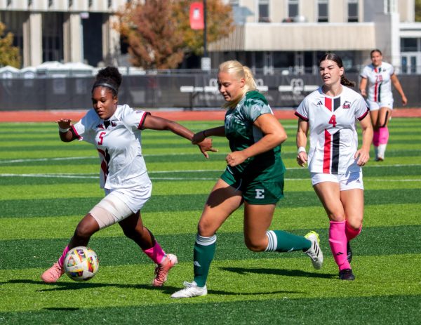 Sophomore forward Tyra King (5) dribbles around an Eastern Michigan University defender on Friday at the NIU Soccer and Track & Field Complex. NIU women's soccer defeated EMU 2-1 for its second conference win of the season. (Marco Alvarez | Northern Star)