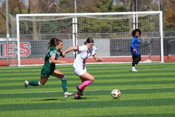 Junior forward Kelsi McLaughlin dribbles the ball while being chased by an Eastern Michigan University defender on Friday at the NIU Soccer and Track & Field Complex. NIU women's soccer defeated Ball State University 3-1 on Thursday, moving into fifth place in the conference standings with a 3-3-3 record. (Marco Alvarez | Northern Star)