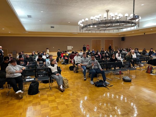 People sit in chairs in the Regency Room of the Holmes Student Center Wednesday for a panel discussion on the 2024 election. The discussion was sponsored by NIU's Department of Political Science. (Devin Oommen | Northern Star)