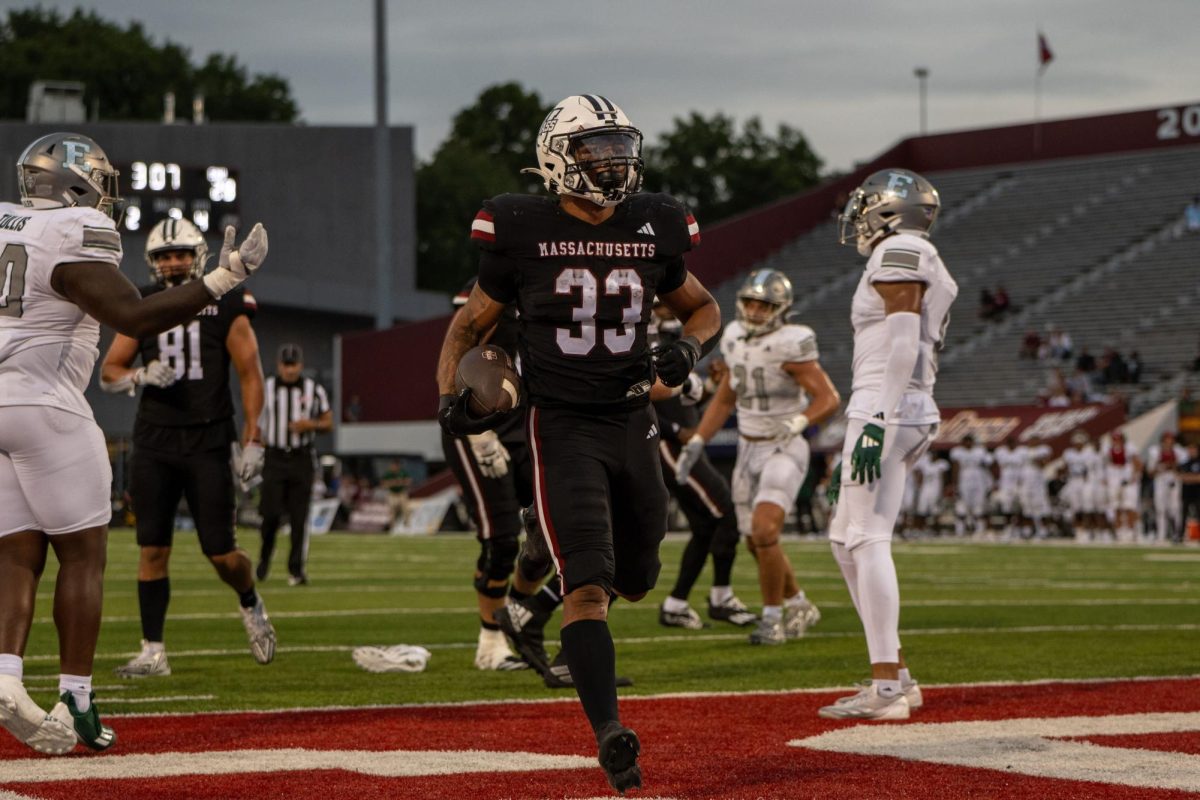 University of Massachusetts sophomore running back CJ Hester (33) rushes for a 2-yard touchdown in the fourth quarter of UMass' 28-14 loss to Eastern Michigan University on Aug. 31 at McGuirk Alumni Stadium in Amherst, Massachusetts. Massachusetts Daily Collegian Head Sports Editor Dean Wendel highlights Hester as a UMass player to watch in Saturday's game against NIU at Huskie Stadium. (Devin Lippman | Massachusetts Daily Collegian)