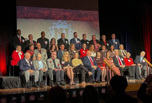 NIU Athletics Hall of Fame members and inductees gather on stage on Friday in the Duke Ellington Ballroom. Seven new members of the Hall of Fame were inducted as part of the 36th induction ceremony. (Skyler Kisellus | Northern Star)