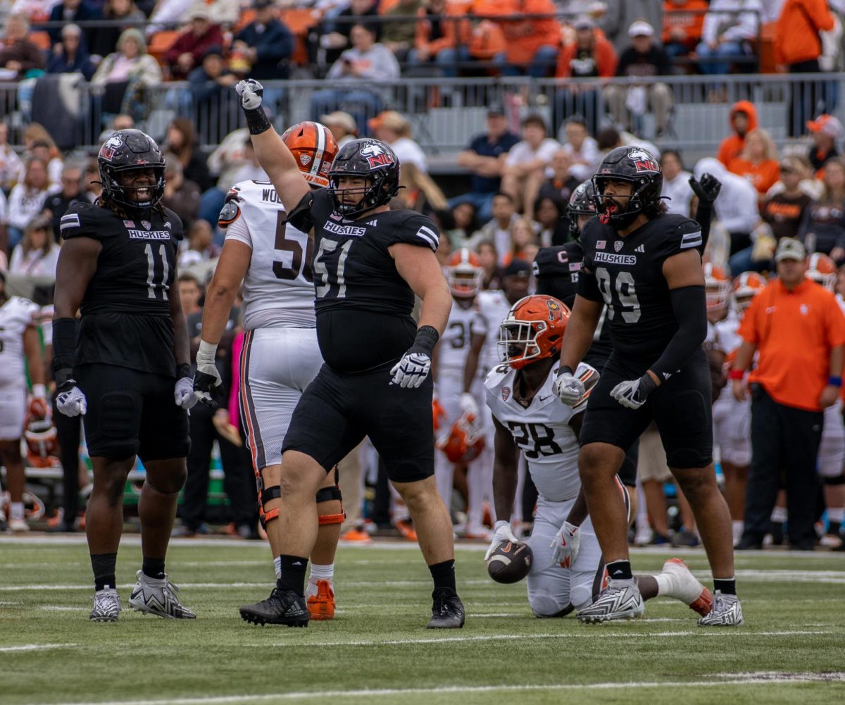  NIU senior defensive tackle Cade Haberman (51) celebrates after tackling Bowling Green senior running back Jaison Patterson (28). The Huskies defense held Bowling Green scoreless for the final 54 minutes of the game. (Tim Dodge | Northern Star) 