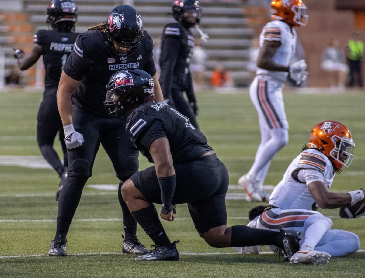 NIU redshirt junior defensive tackle Skyler GIll-Howard (0) celebrates after tackling Bowling Green State University redshirt freshman quarterback Lucian Anderson III in the fourth quarter of the Huskies' 17-7 win against the Falcons at Doyt L. Perry Stadium in Bowling Green, Ohio. Gill-Howard was named Mid-American Conference Defensive Player of the Week for the first time in his career Monday. (Tim Dodge | Northern Star)