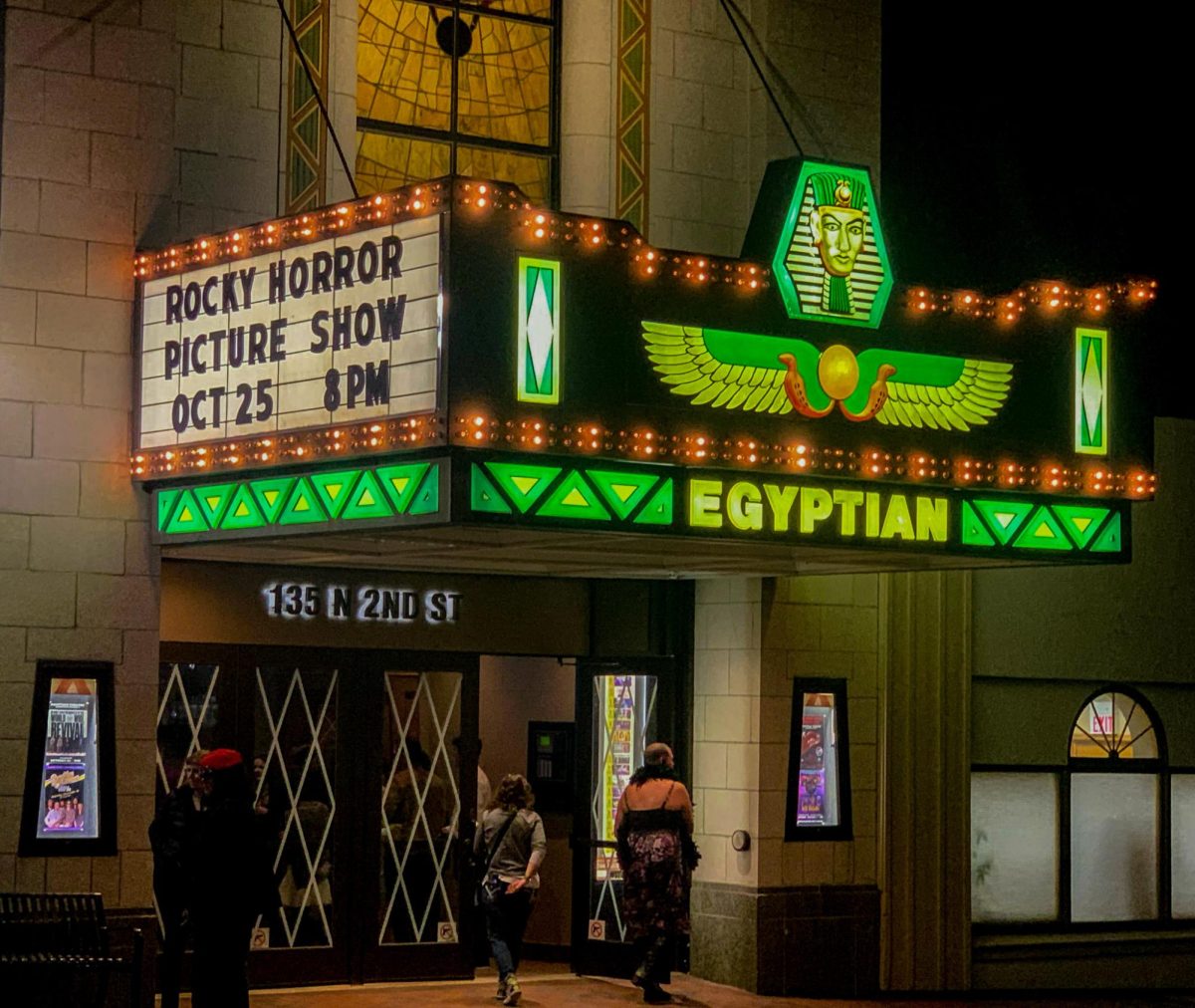 Attendees walk into the Egyptian Theatre, 135 N. Second St., to see the “Rocky Horror Picture Show.” This showing included a shadow cast performance from the Irrational Masters. (Yari Tapia | Northern Star)