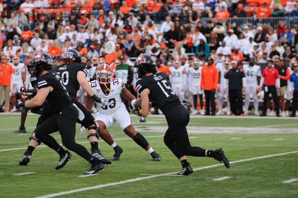 Redshirt freshman quarterback Josh Holst (15) carries the ball in the first half on Saturday against the Bowling Green State University Falcons at Doyt L. Perry Stadium. Holst entered the game as quarterback after an injury to redshirt junior quarterback Ethan Hampton in the second quarter. (Tim Dodge | Northern Star)