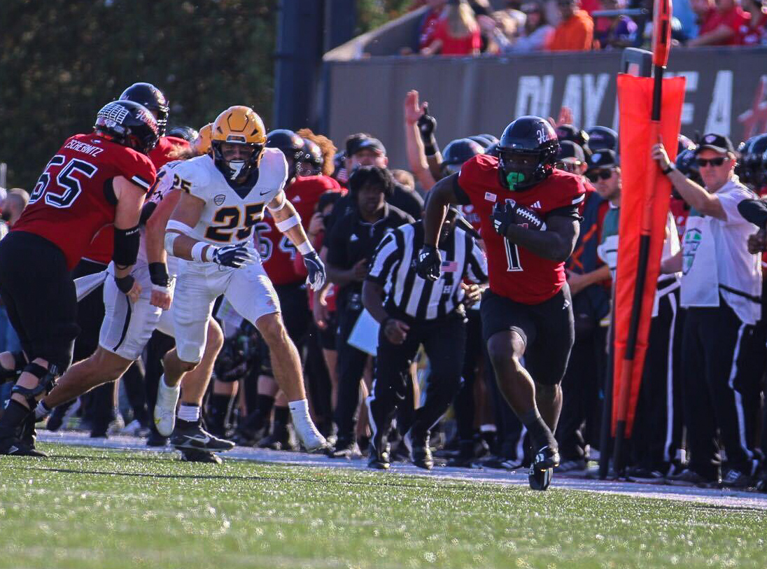 Senior running back Antario Brown runs down the sidelines on Saturday at Huskie Stadium. Brown accumulated 53 rushing yards at halftime in his first appearance since Oct. 5. (Tim Dodge | Northern Star)