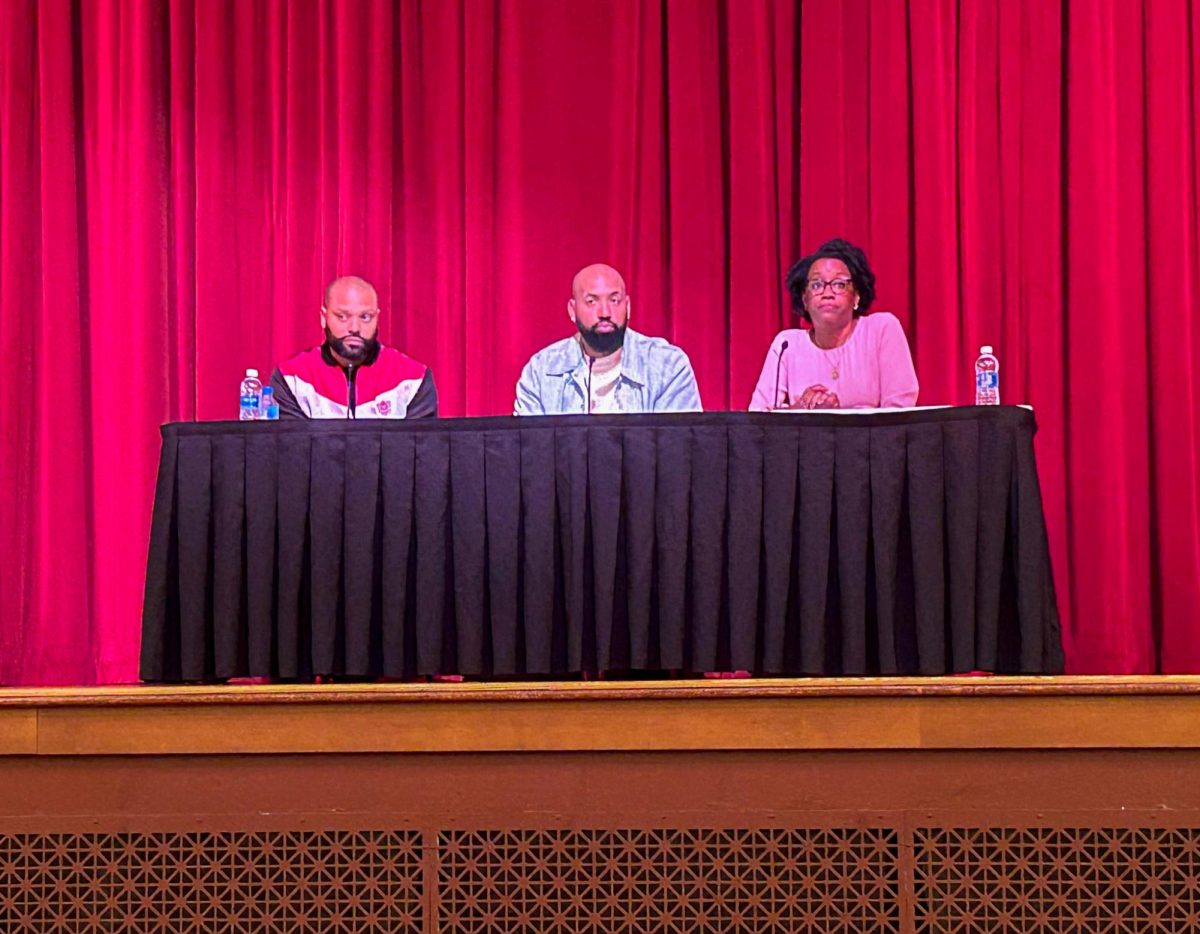 Rashad Bilal, co-founder and co-host of the Earn Your Leisure podcast, Troy Millings, co-founder and co-host of the Earn Your Leisure podcast and Lauren Underwood, representative in Illinois' 14th congressional district, sit at a table in the Altgeld Hall Auditorium Tuesday. Underwood, Bilal and Millings held a town hall event about financial literacy from 11 a.m. to 2 p.m. (Emily Beebe | Northern Star)