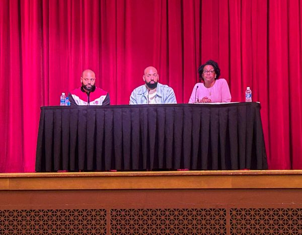 Rashad Bilal, co-founder and co-host of the Earn Your Leisure podcast, Troy Millings, co-founder and co-host of the Earn Your Leisure podcast and Lauren Underwood, representative in Illinois' 14th congressional district, sit at a table in the Altgeld Hall Auditorium Tuesday. Underwood, Bilal and Millings held a town hall event about financial literacy from 11 a.m. to 2 p.m. (Emily Beebe | Northern Star)