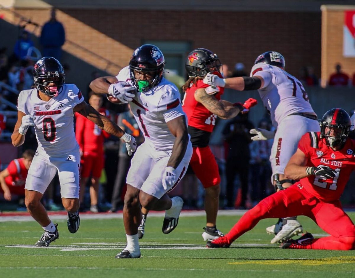 NIU senior running back Antario Brown (1) sprints toward the end zone after spinning around a Ball State University defender Saturday at Scheumann Stadium in Muncie, Indiana. Brown scored a 34-yard touchdown on the play and got another in the fourth quarter to record his second two-touchdown performance of the season. (Tim Dodge | Northern Star)