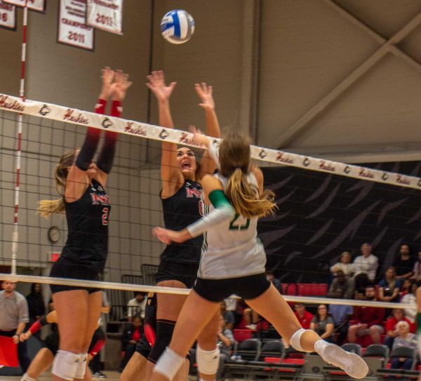 Freshman setter Ella Strausberger (2) and freshman middle blocker Rylea Alvin (8) attempt to block an attack from the Ohio University Bobcats on Friday at Victor E. Court. Strausberger had a season-high 40 assists as NIU volleyball was swept by the Bobcats. (Marco Alvarez | Northern Star)