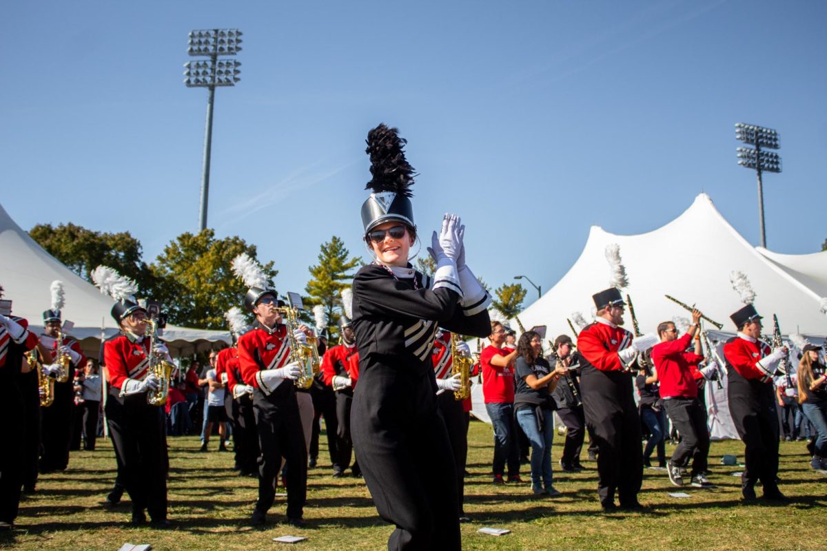  A marching band drum major claps along to “#5 (Hey Song)” performed by the NIU Marching Band joined by band alumni. The marching band performed five songs during the Yard then marched down Stadium Drive South around Huskie Stadium. (Totus Tuus Keely | Northern Star)