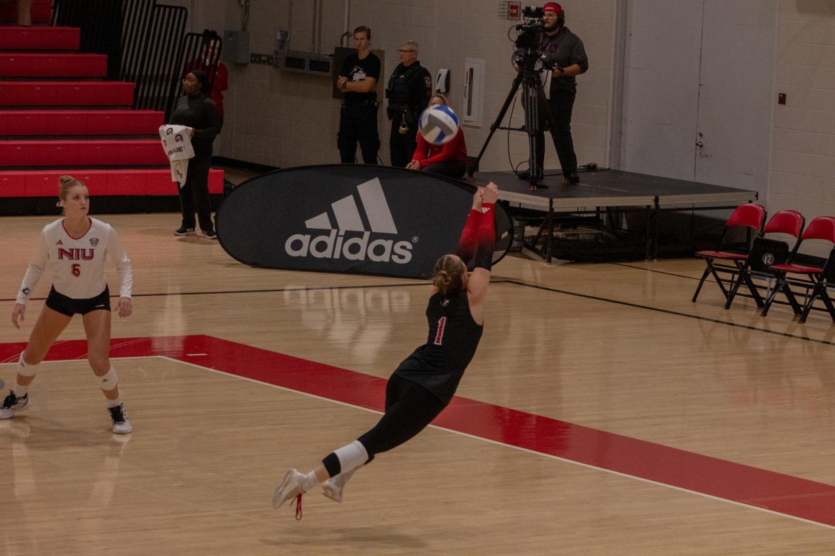 Senior libero Crew Hoffmeier leaps to bump the ball backward to prevent Kent State University from scoring. Hoffmeier had 9 digs against Central Michigan University on Friday. (Northern Star File Photo) 