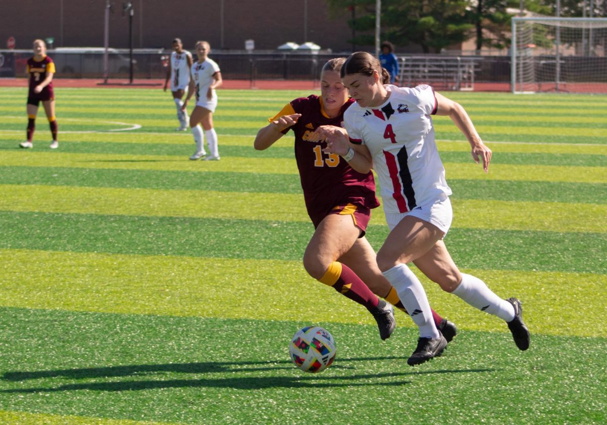 Junior forward Kelsi McLaughlin (4) pushes forward towards the goal on Sept. 26 as a defender from Central Michigan University pursues her. NIU women's soccer lost 2-1 to Bowling Green State University for its third-straight loss. (Northern Star File Photo)