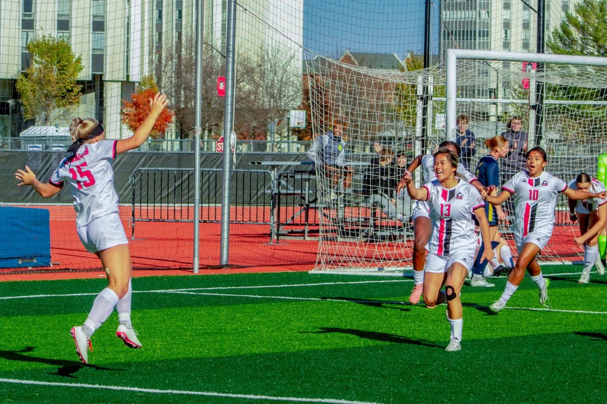 Graduate student midfielder Abby Zipse (15) jumps in celebration after scoring a goal from her corner kick with four minutes remaining on Sunday at the NIU Soccer and Track & Field Complex. NIU women's soccer tied 1-1 against the University of Toledo Rockets for the Huskies' final home game of the season. (Totus Tuus Keely | Northern Star)