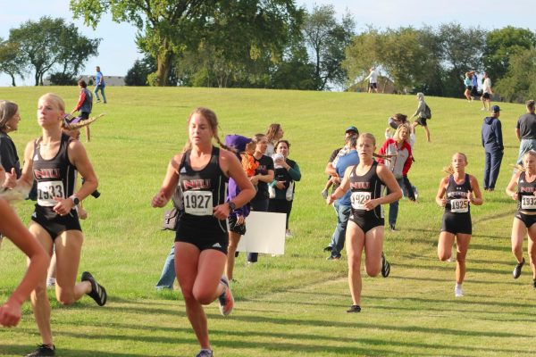 NIU runners from left, senior Emma Vorpagel, freshman Rachel Dietrich, sophomore Morgan Gioia and senior Olivia Southby run on Sept. 6 at the 5k North 40 course. NIU cross country finished in eighth place on Friday at the Bradley Pink Classic. (Totus Tuus Keely | Northern Star)