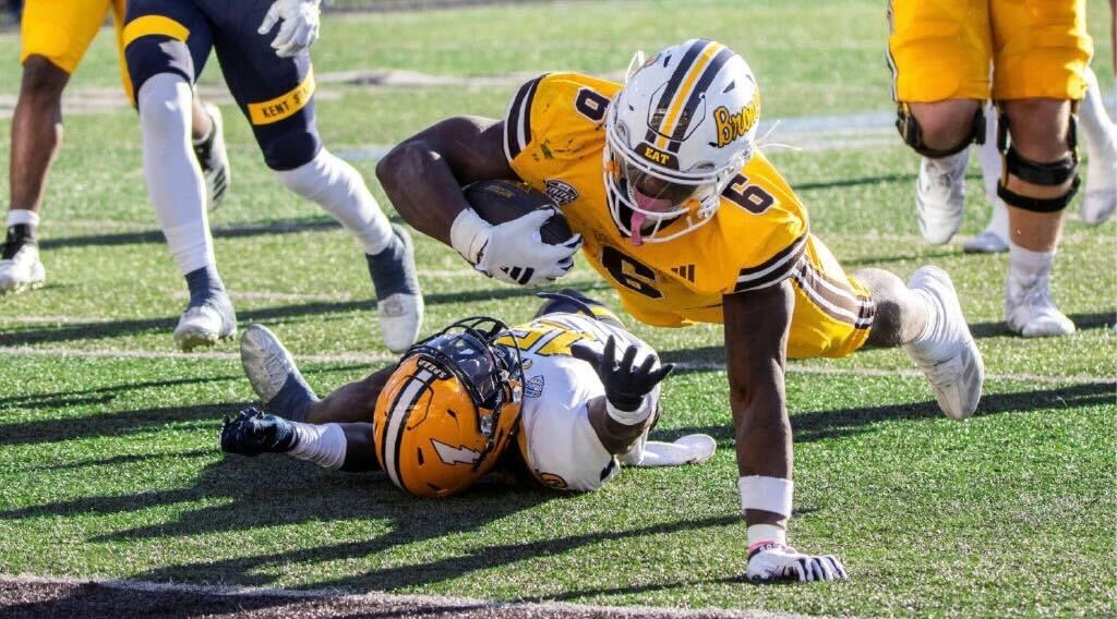 Western Michigan University redshirt sophomore running back Jalen Buckley (6) lunges into the end zone to finish off a 17-yard touchdown run in the Broncos’ 52-21 win over Kent State University on Oct. 26 at Waldo Stadium in Kalamazoo, Michigan. Buckley will be one of three running backs at Western Michigan’s disposal against NIU on Wednesday. (Nicholas Kahl | Western Herald)