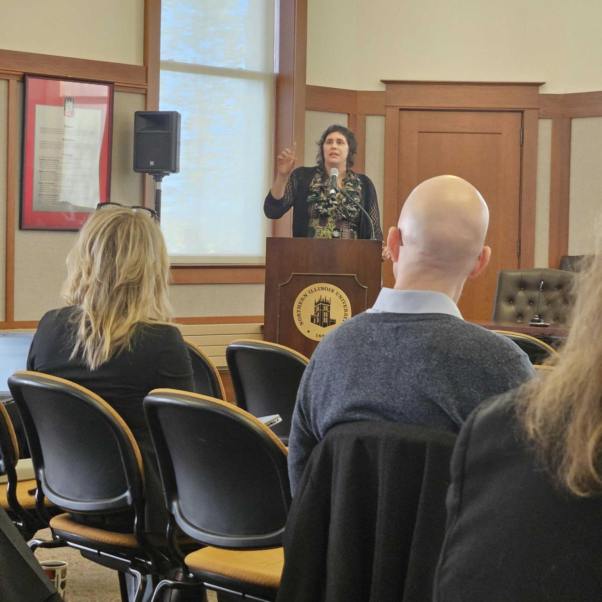 Lindsay Harris, educational psychology co-director, speaks in front of the board of trustees about her study regarding word learning in children with visual disabilities. Other topics discussed at the Board of Trustees meeting were approval for Matthew Deitch tenure of associate professor in the Department of Earth, Atmosphere and Environment and approval for the termination of Lorado Taft Building (Kahlil Kambui | Northern Star)