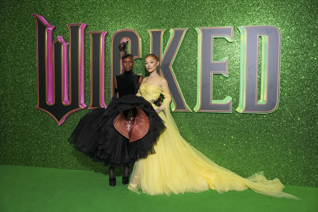 Cynthia Erivo (left) and Ariana Grande pose for photographers upon arrival at the premiere of the film "Wicked" on Monday in London. "Wicked" tells the story of what happened before Dorothy arrived in Oz. (Photo by Scott A Garfitt/Invision/AP)