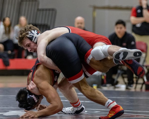 NIU wrestling then-redshirt freshman Jacob Brya takes down Southern Illinois University Edwardsville then-redshirt freshman Eric Almarinez last season in February. The Huskies competed at the Michigan State Open on Saturday with six wrestlers reaching the podium. (Northern Star File Photo) 