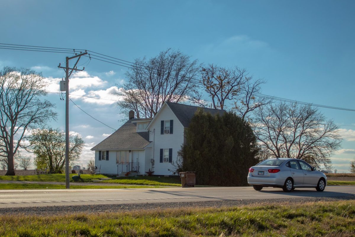 A car passes a farmhouse at 2036 W. Lincoln Highway which will remain after construction of the solar farm in the surrounding agriculture fields. The DeKalb City Council approved a request from PSE Huber IL Solar LLC to build a five megawatt solar farm. (Totus Tuus Keely | Northern Star)