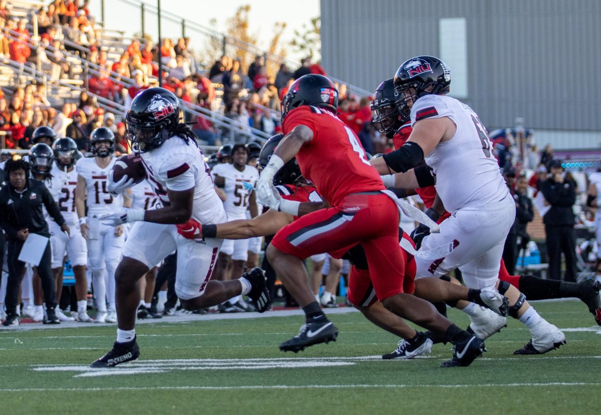 Freshman running back Telly Johnson Jr. (22) runs to the right side of the field on Oct. 26 at Scheumann Stadium. Johnson scored his first career touchdown in the second quarter against Western Michigan University on Wednesday. (Northern Star File Photo)