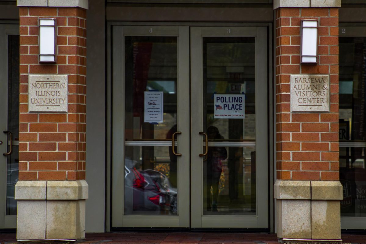 Polling place signs are posted on the west doors of the Barsema Alumni and Visitor’s Center. In Illinois, voters are able to register on Election Day at Grace Period Voting at the East Conference Room located at 110 E. Sycamore St., Sycamore, for DeKalb County voters.  (Totus Tuus Keely | Northern Star)