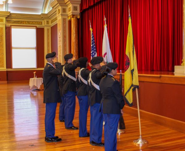  NIU veterans and military students stand as they salute the flags during the Veterans Day flag ceremony. Veterans Day originally was called Armistice Day to celebrate the agreement between Allied nations and Germany to end World War I. (Nia Jackson | Northern Star) 