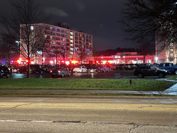 Lights from police cars, fire trucks and ambulances reflect off of the University Plaza apartments, located at 900 Crane Drive on Monday night. Fire trucks, police and ambulances responded to a call about a fire late Monday night at University Plaza. (Ryan Day | Northern Star)

 