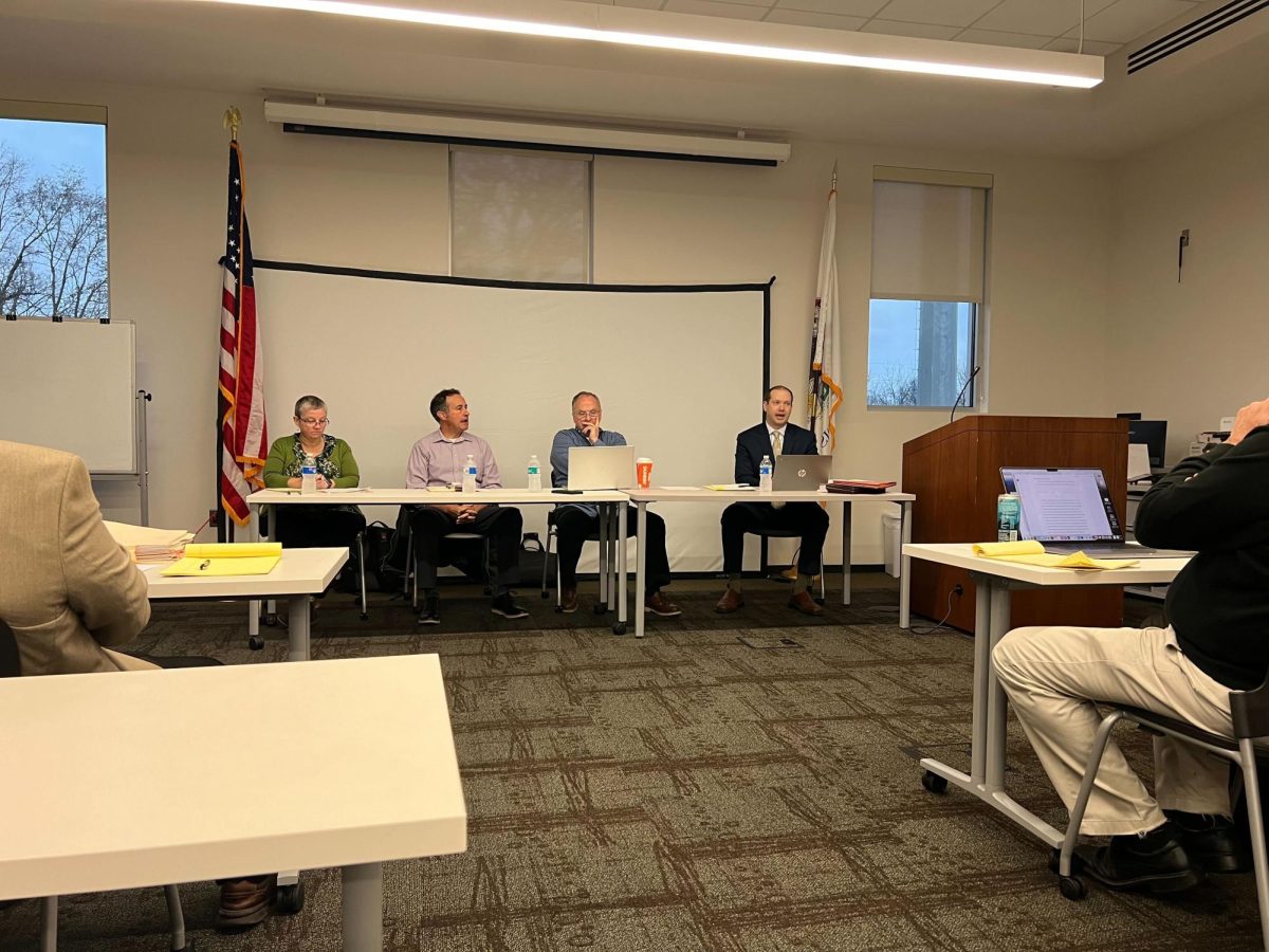 (left) Ruth Scott, executive assistant for the City of DeKalb, Mike Verbic, 6th Ward Alderman, Tracy Smith, 3rd Ward Alderman, and Matthew Rose, DeKalb City Attorney sit at a table Tuesday morning during a meeting to determine if Linh Nguyen would be allowed to run for mayor or not. Linh Nguyen has been disqualified from the ballot, but her team plans to appeal the decision. (Devin Oommen | Northern Star)