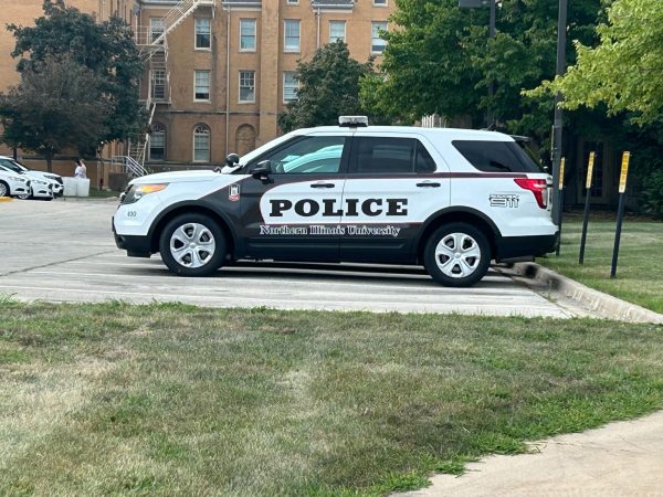 An NIU Police car sits parked at the NIU Police Department building, located at 395 Wirtz Drive. Crimes such as theft and stalking were reported in October 2024 on NIU's campus. (Emily Beebe | Northern Star)