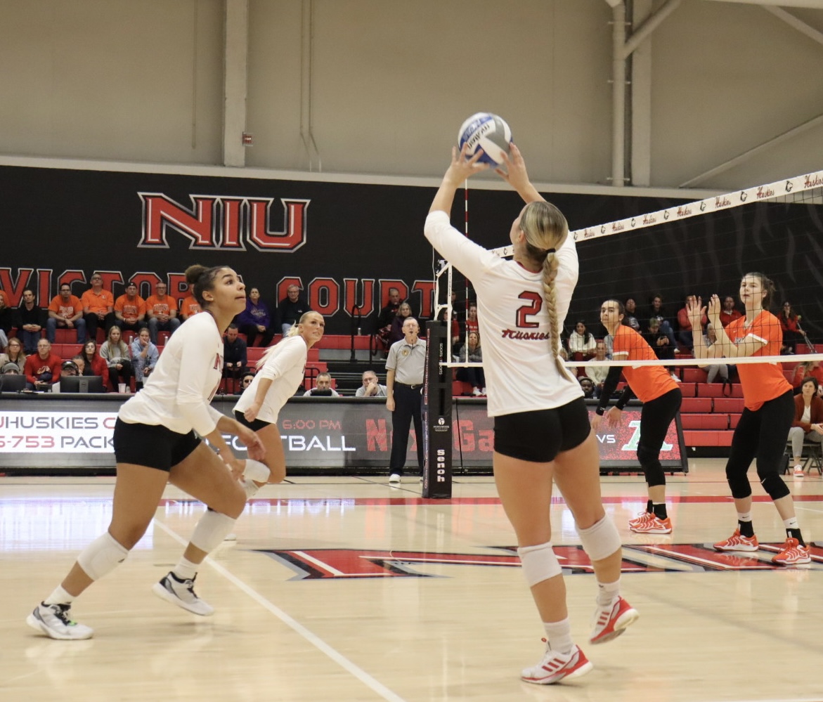 Freshman setter Ella Strausberger (2) sets up senior middle blocker Charli Atiemo for a chance at a kill. Atiemo struck her 1,000th kill Friday against Bowling Green State University and is the 23rd Huskie to ever do so. (Marco Alvarez | Northern Star)