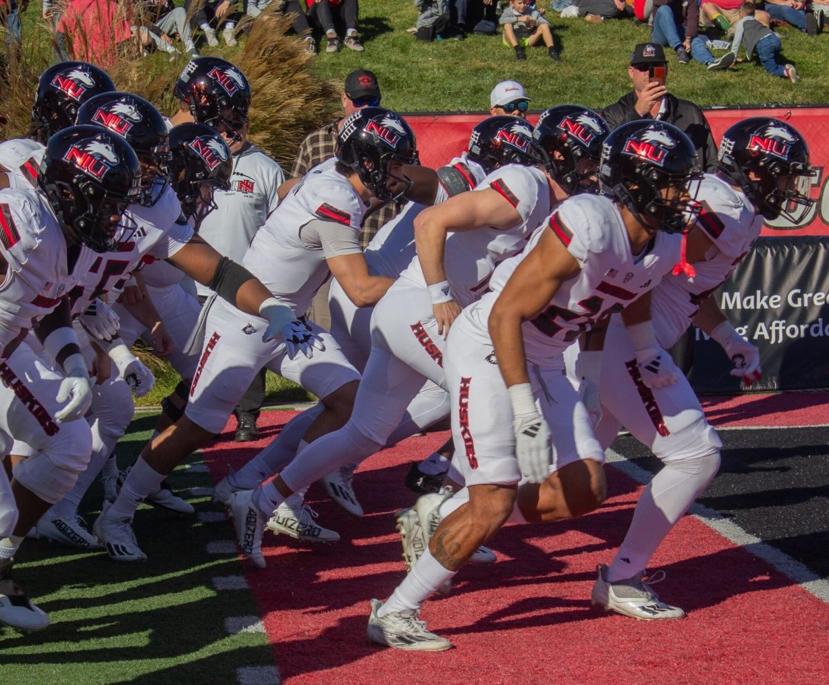 The NIU football team rushes onto the field before kickoff of the Huskies’ 25-23 loss to Ball State University on Oct. 26 at Scheumann Stadium in Muncie, Indiana. NIU is 4-4, 1-3 MAC, with four games left in the 2024 regular season. (Tim Dodge | Northern Star)