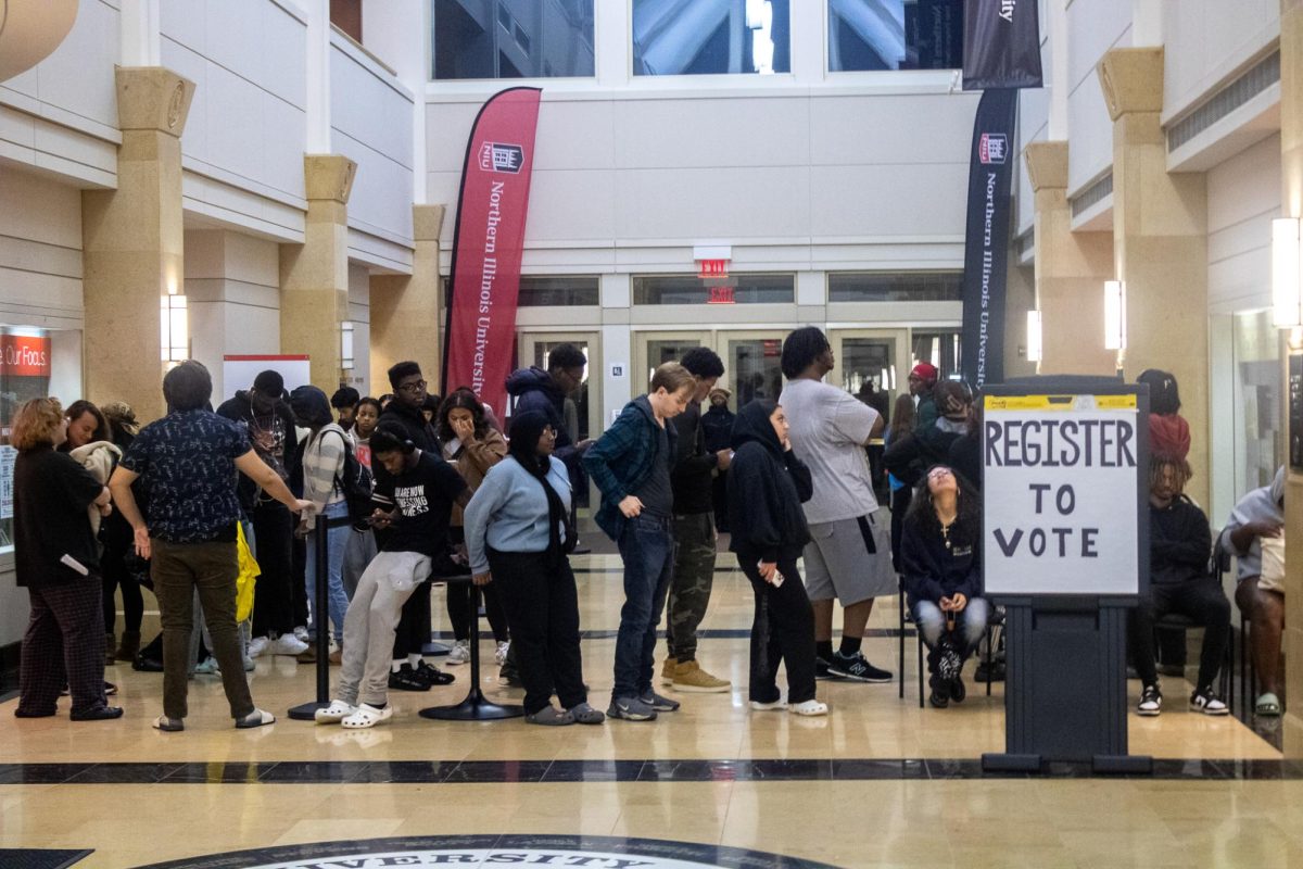 Voters stand in line inside the Barsema Alumni Visitors Center waiting to vote. The lines inside the polling place were long inside as poll close approached at 7 p.m. (Tim Dodge | Northern Star)
