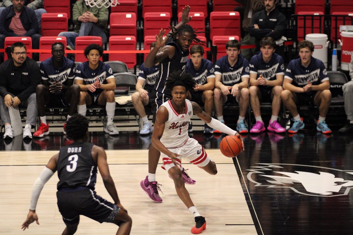 NIU men's basketball guard Quentin Jones (1) drives toward the basket Tuesday in the Huskies' game against Monmouth University. After traveling to Peoria Saturday, the Huskies drop to 2-2 following a 76-60 defeat against the University of Bradley Braves. (Tim Dodge | Northern Star)