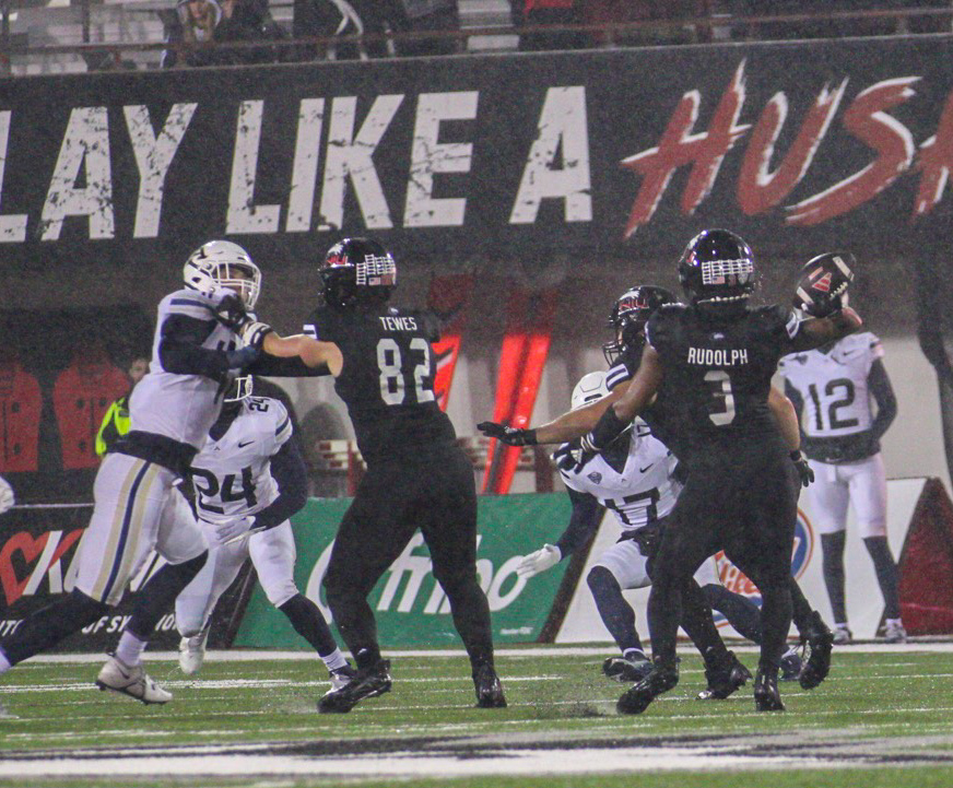 NIU football redshirt senior wide receiver Trayvon Rudolph winds up before launching his 39-yard touchdown pass  at the end of the first quarter Wednesday against the University of Akron Zips. The Huskies finished the first half with a 23-16 lead. (Tim Dodge | Northern Star)