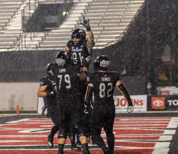 NIU senior tight end Grayson Barnes (81) is lifted up in the endzone by redshirt senior offensive lineman J.J Lippe (79) and celebrates in the endzone after catching a touchdown pass during the second quarter. Barnes had one catch for the game and it came on the touchdown pass. (Tim Dodge | Northern Star) 
