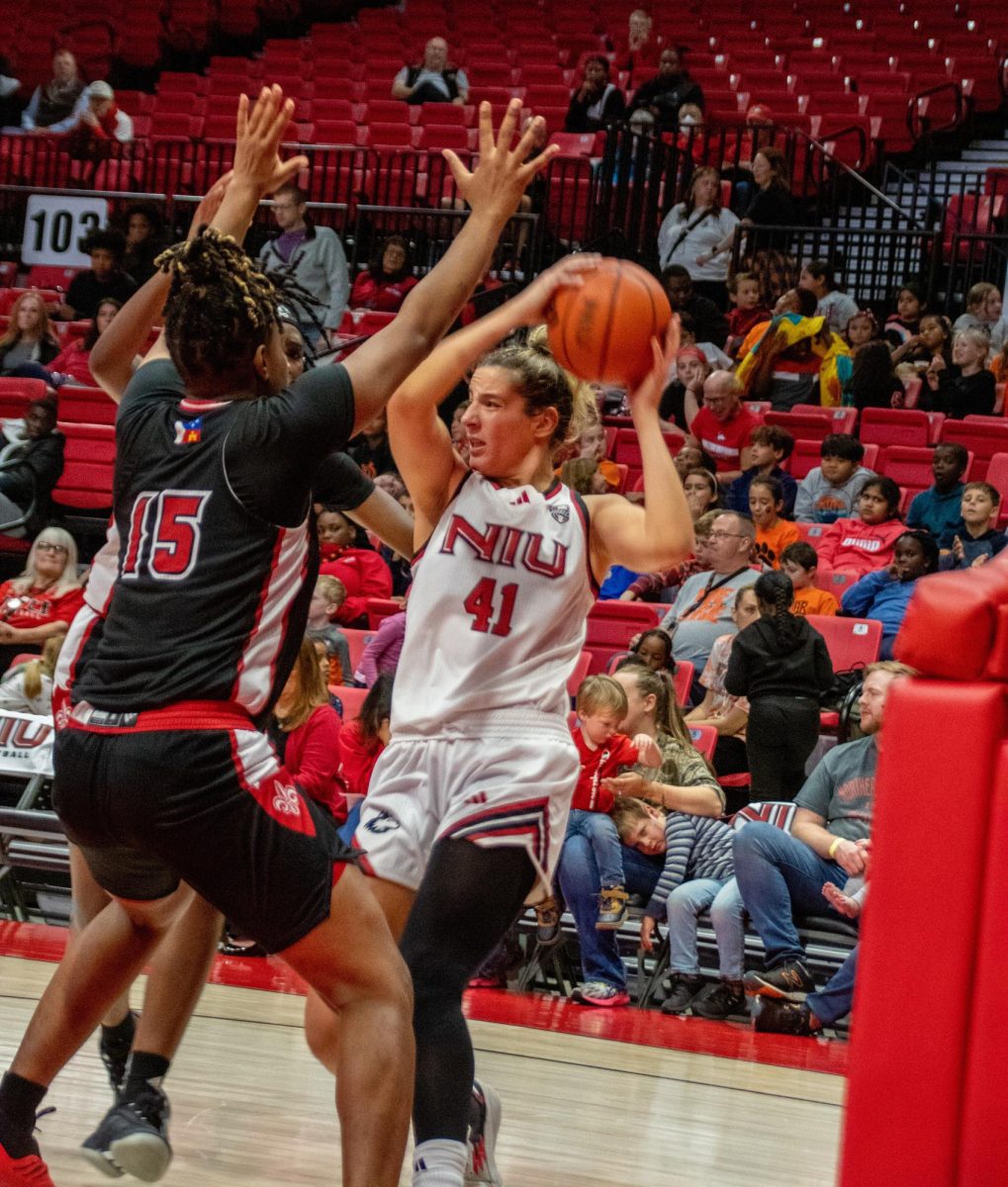 Redshirt sophomore forward Brooke Blumenfeld (41) looks for someone to pass to while University Louisiana at Lafayette sophomore forward Uniyah Franklin (15) guards her on Monday. Blumenfeld led the Huskies with 18 points as NIU lost to the University of St. Thomas 75-68 on Sunday. (Katherine Follmer | Northern Star)