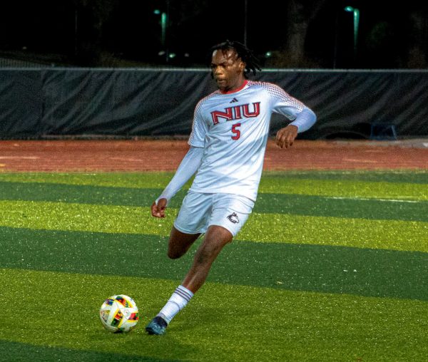 Sophomore defender Ethan Wilson (5) passes the ball on Friday at the NIU Soccer and Track & Field Complex. NIU men's soccer was eliminated from playoff contention with a 3-2 loss to Drake University on Friday. (Totus Tuus Keely | Northern Star)