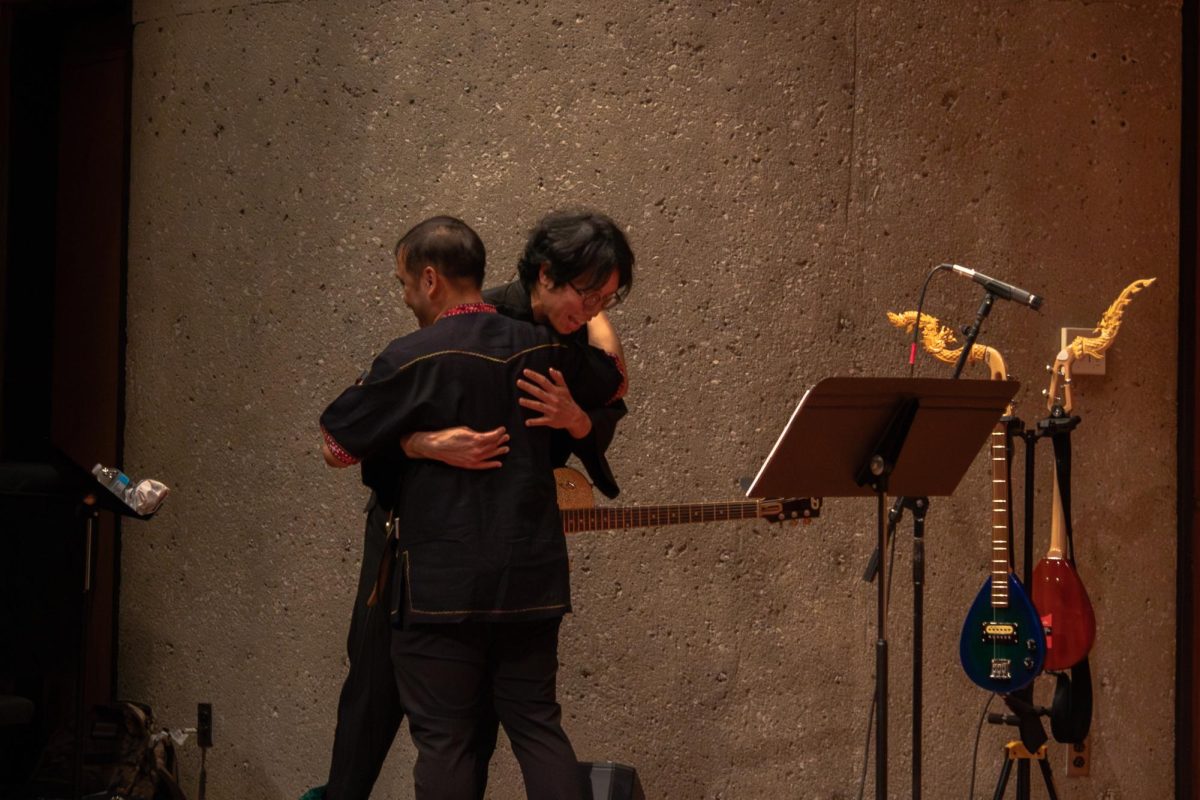  Ajarn Chamni Sriparam, director for the Thai Music Ensemble, hugs Sathapat Sangsuwan, a guest performer, after their performance of an electronic version of “Nok Sai Bin Kham Tung.” The electronic version was then followed by the Ponglang Ensemble of the Thai Music Ensemble performance of the same piece. (Totus Tuus Keely | Northern Star)